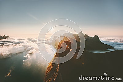 Sunset mountains over sea and clouds landscape Stock Photo