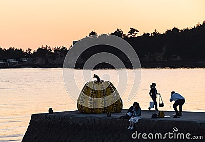 Sunset at naoshima: Tourists and the pumpkin. Editorial Stock Photo