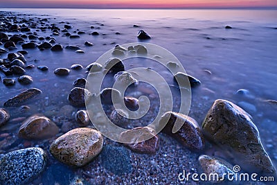 Sunset ocean stones. Baltic Sea coast, Poland. Stock Photo