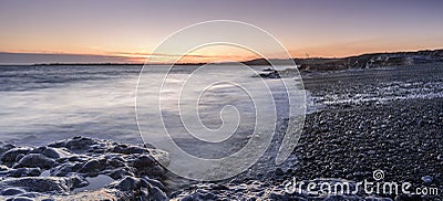 Sunset off the South Wales coast. Ogmore-by-Sea is a popular destination to swim and surf. Stock Photo