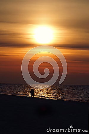 Sunset over the Baltic sea in Poland Europe with a couple of people in love on the beach Stock Photo