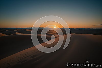 Sunset over a calm desert landscape Stock Photo