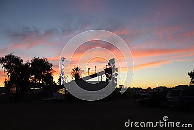 Sunset over carnival rides Stock Photo