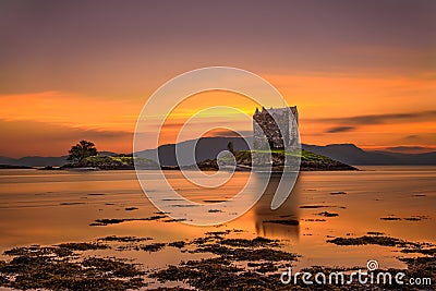 Sunset over Castle Stalker, Scotland, United Kingdom Stock Photo