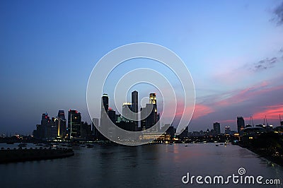 Sunset over city skyline Stock Photo