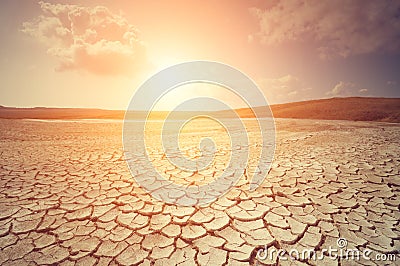 Sunset over cracked earth Stock Photo
