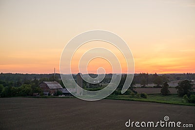 Sunset over farm Stock Photo