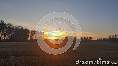 Sunset over a field outside the city Stock Photo