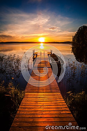 Sunset over the fishing pier at the lake in Finland Stock Photo