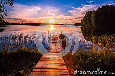 Sunset over the fishing pier at the lake in Finland Stock Photo