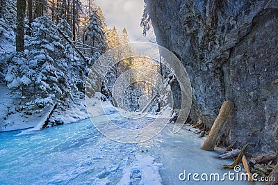Sunset over frozen creek in Sucha Bela gorge in Slovak Paradise during winter Stock Photo