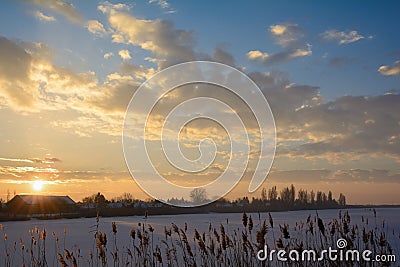 Sunset over the frozen Tisa river covered with snow Stock Photo