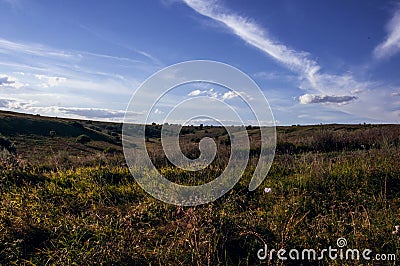 Sunset over green hills Stock Photo