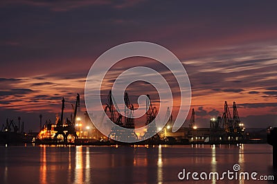 Sunset over an industry harbor with cranes in Bulgaria, Varna Stock Photo