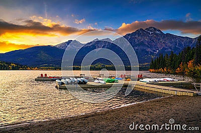 Sunset over jetty with boats on the Pyramid Lake in Jasper National Park, Canada Stock Photo