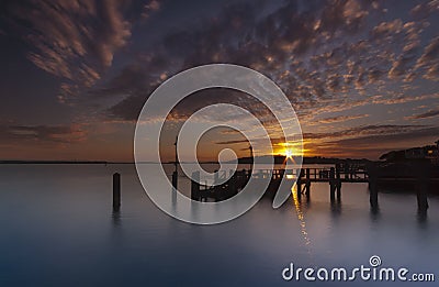 Sunset over a jetty near Brownsea Island in Poole Harbour Stock Photo