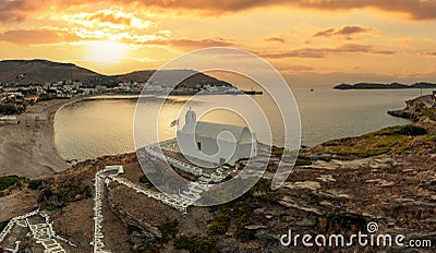 Greece, Kea Tzia island. Small white church on a rocky hill, over Korissia port at sunset Stock Photo