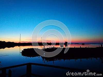 On a pier. Sunset over the lake in Rabocheostrovsk, Karelia. Stock Photo