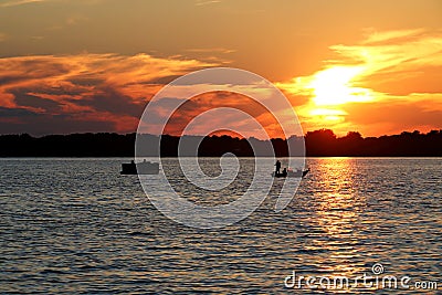 Sunset over Lake Washington with Pontoon and Fishing Boat Stock Photo