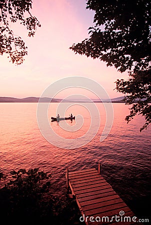 Sunset over Lake Winnipesaukee, NH with canoe Stock Photo