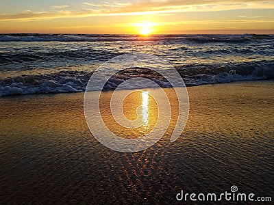 Sunset over the ocean from the beach Stock Photo