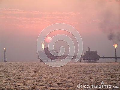 Sunset over oil complex in Persian Gulf Stock Photo