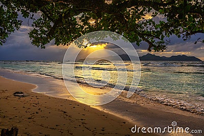 Sunset over Praslin Island seen from Anse Severe Beach at the La Digue Island, Seychelles Stock Photo