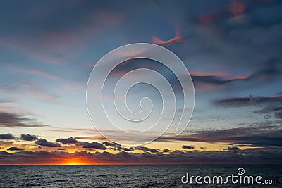 Beautiful sunset over the sea. Colorful cirrus clouds. Stock Photo