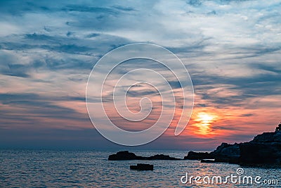 Sunset over the sea, colorful clouds, wide shot. Romantic picture full of colors Stock Photo