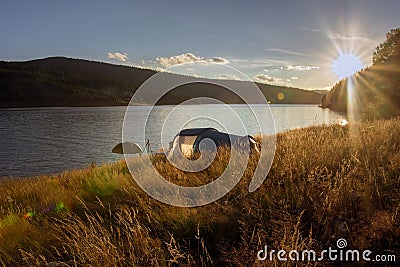 Sunset over the tent camped lakeside Stock Photo