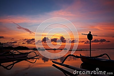 Sunset over traditional fishing boats on Bali Stock Photo