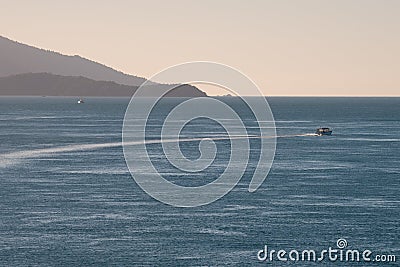 Sunset over a tropical beach bay with boat Stock Photo