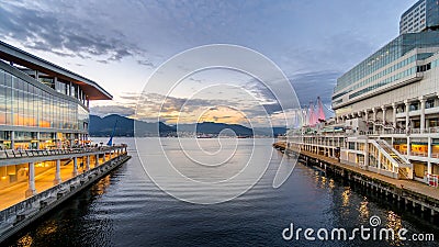 Sunset over the Vancouver Harbour between the Seaplane Terminal and the Canada Place Cruise Terminal in Downtown Vancouver Editorial Stock Photo