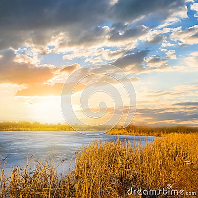 Sunset ower a small blue lake Stock Photo