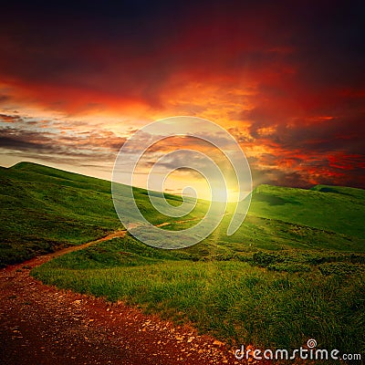 Sunset and path through a meadow Stock Photo