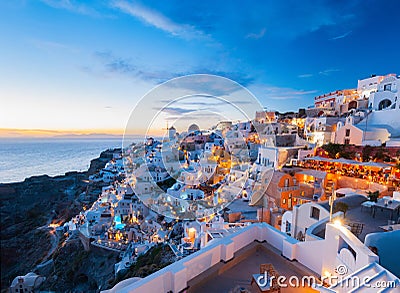 Sunset and the picturesque Oia village, Santorini, Greece. Stock Photo