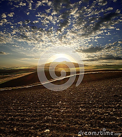 Sunset On Plowed Land Stock Photo