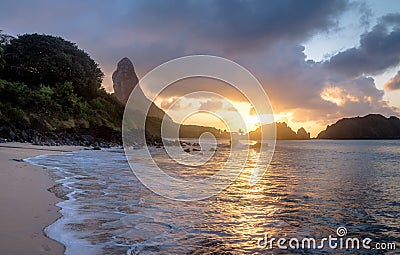 Sunset at Praia do Cachorro Beach with Morro do Pico on background - Fernando de Noronha, Pernambuco, Brazil Stock Photo