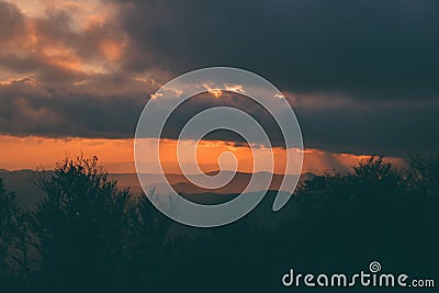 Stunning alpine landscape with golden skies and dramatic clouds Stock Photo