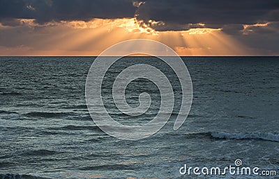 Sunset rays over ocean Stock Photo