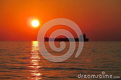 Sunset red light above the sea, ship silhouette Stock Photo