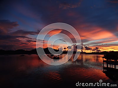 Sunset red violet light reflection at sea water, Coron, Philippines, Stock Photo