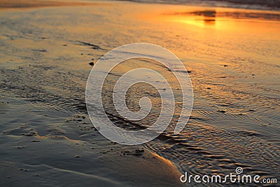 Sunset reflection off low tide waters Stock Photo