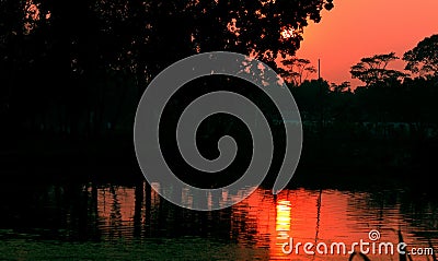 Sunset reflection water pond tree home rural Stock Photo