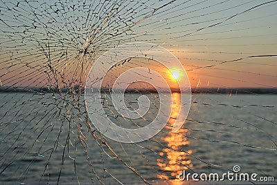 Sunset in river throw the broken glass Stock Photo