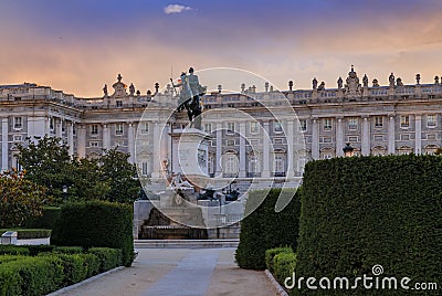 Sunset by the Royal Palace or Palacio Real with king Philip IV statue in Plaza de Oriente in Madrid Spain built in 1639 Stock Photo