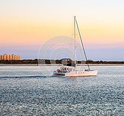 Sunset Sail at Ponce Lighthouse Jetty in Florida Stock Photo