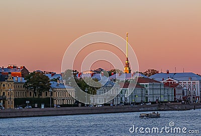 Sunset in Saint Petersburg over the Neva river with the view of the Palace Embankment and the Peter and Paul Fortress spire Stock Photo