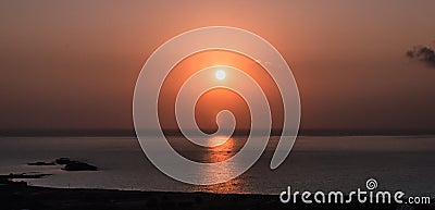 Sunset on sea. Bright sun on sky. beach landscape Stock Photo