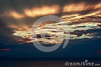 Sunset on the sea coast in cloudy weather Stock Photo